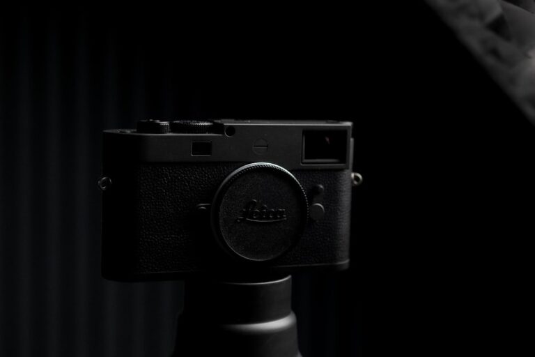 A close-up shot of the Leica Cine Compact 1 projector on a studio table, showcasing its aluminum body and lens.