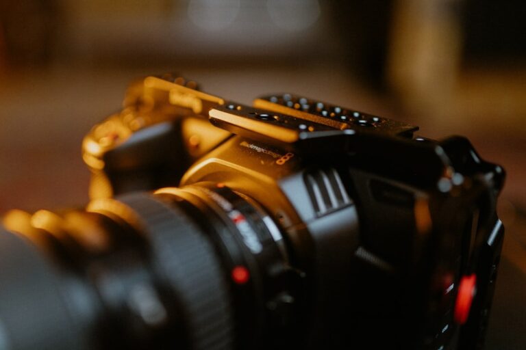 A close-up of the Metabones TruePDAF EF-MFT adapter mounted between a Canon lens and a Micro Four Thirds camera body.