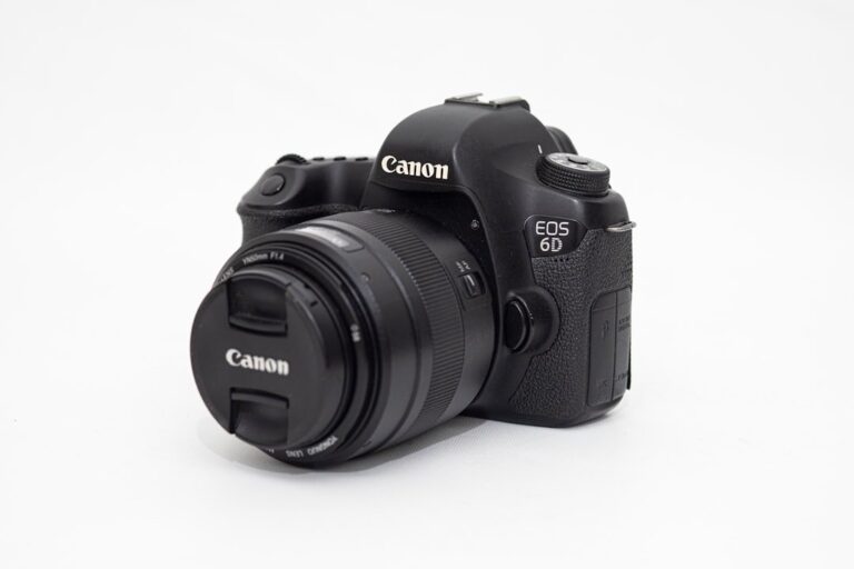 A close up product shot of the Canon RF 24-70mm f/2.8L IS USM lens, highlighting its black body and red L-series ring.