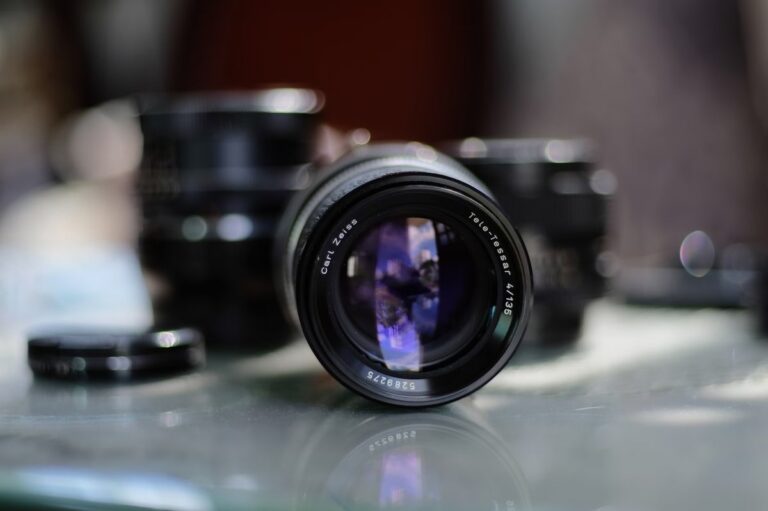 A close-up of a black Zeiss Otus lens, highlighting its premium build and design.