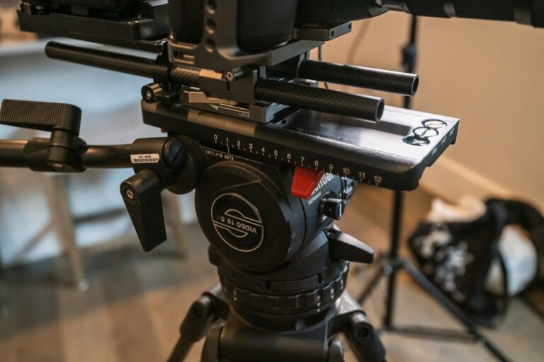 A close-up shot of the Harlowe Rocket Air's integrated fluid head, showing its sleek carbon fiber and aluminum construction against a dark background.