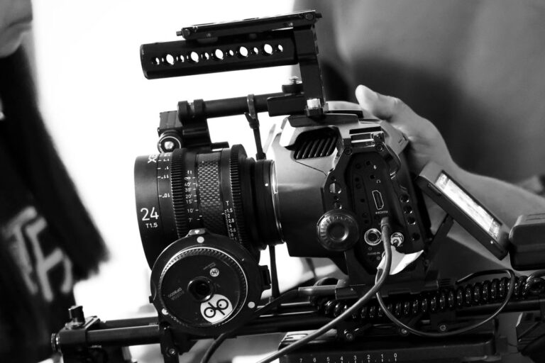 A professional PL mount cinema lens being attached to a mirrorless camera via the Kipon PL Variable ND adapter.