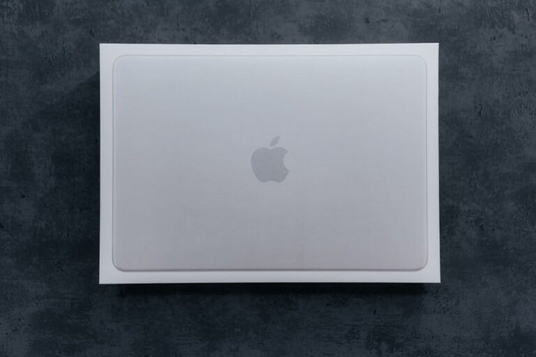 A sleek new MacBook Neo laptop shown in the Citrus yellow finish, open on a clean, modern desk.